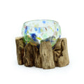 Small molten coloured glass bowl on natural wood base