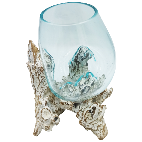 Large decorative bowl of molten glass set on whitewashed wood base
