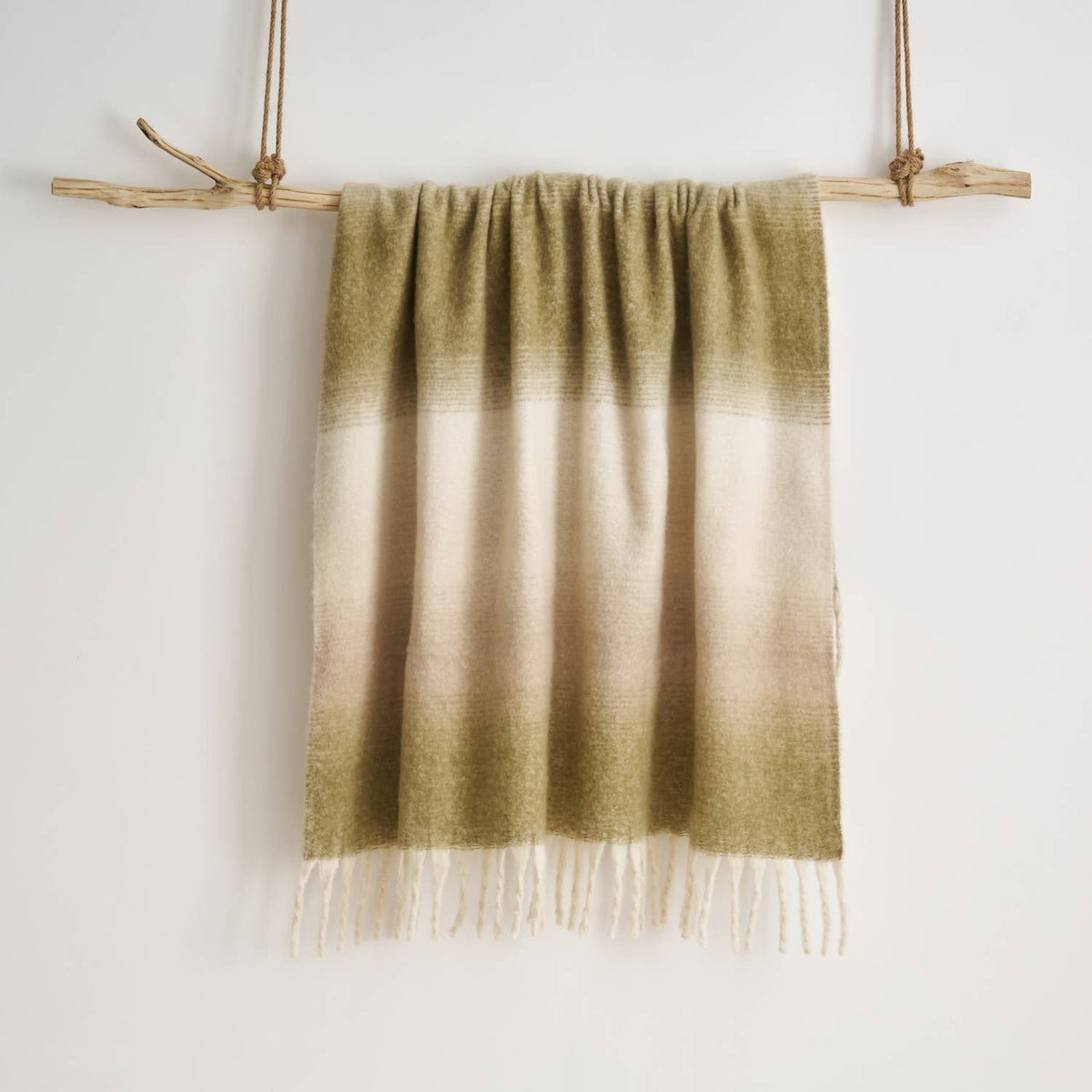 Corner detail of the Highland Mist Ombre Throw showing the tasselled fringe, Croft & Cleo