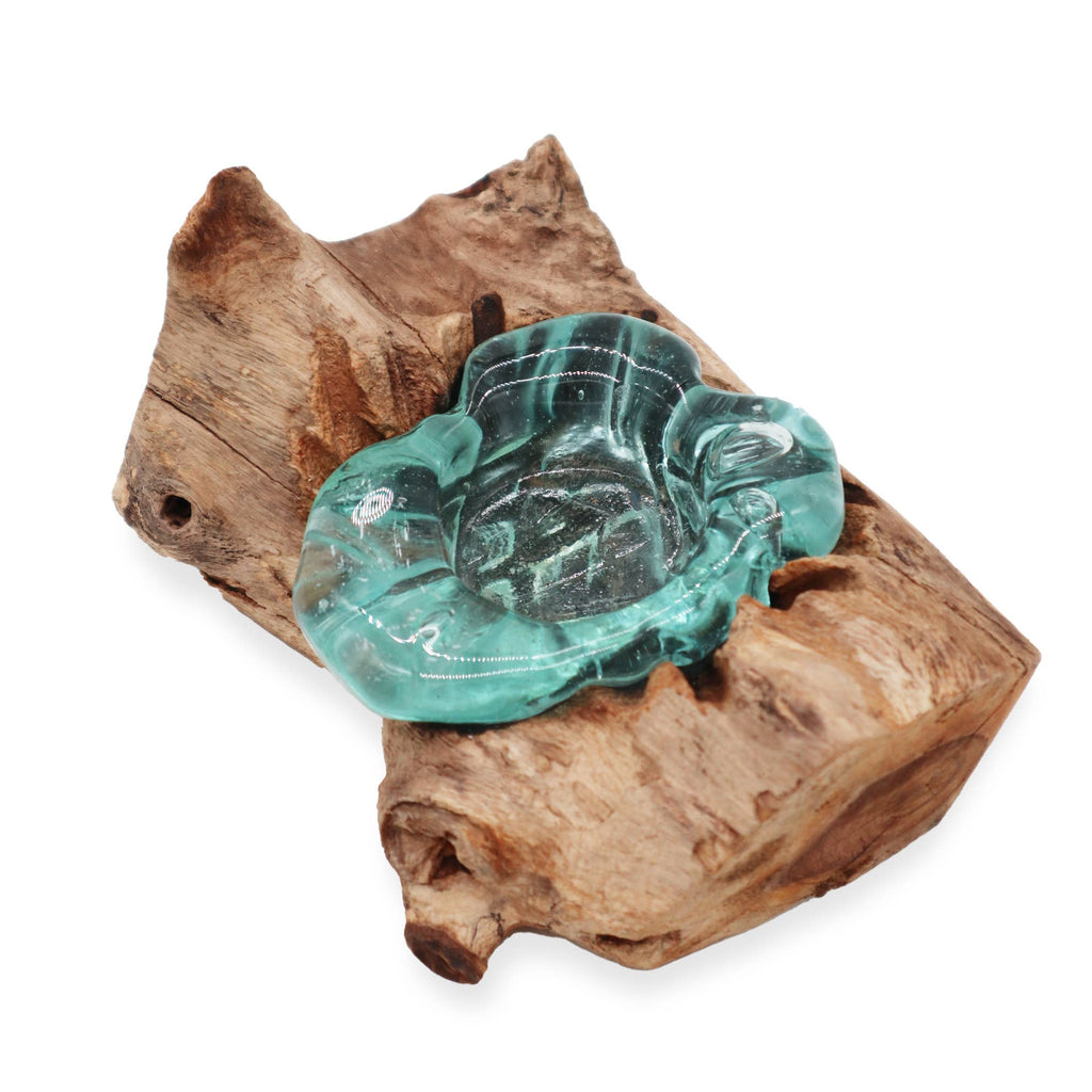 Molten glass tealight holder lit, casting a warm glow