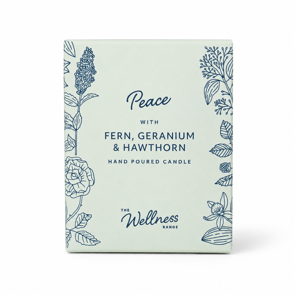 Peace Wellness glass candle — lit, casting a warm glow, Croft & Cleo