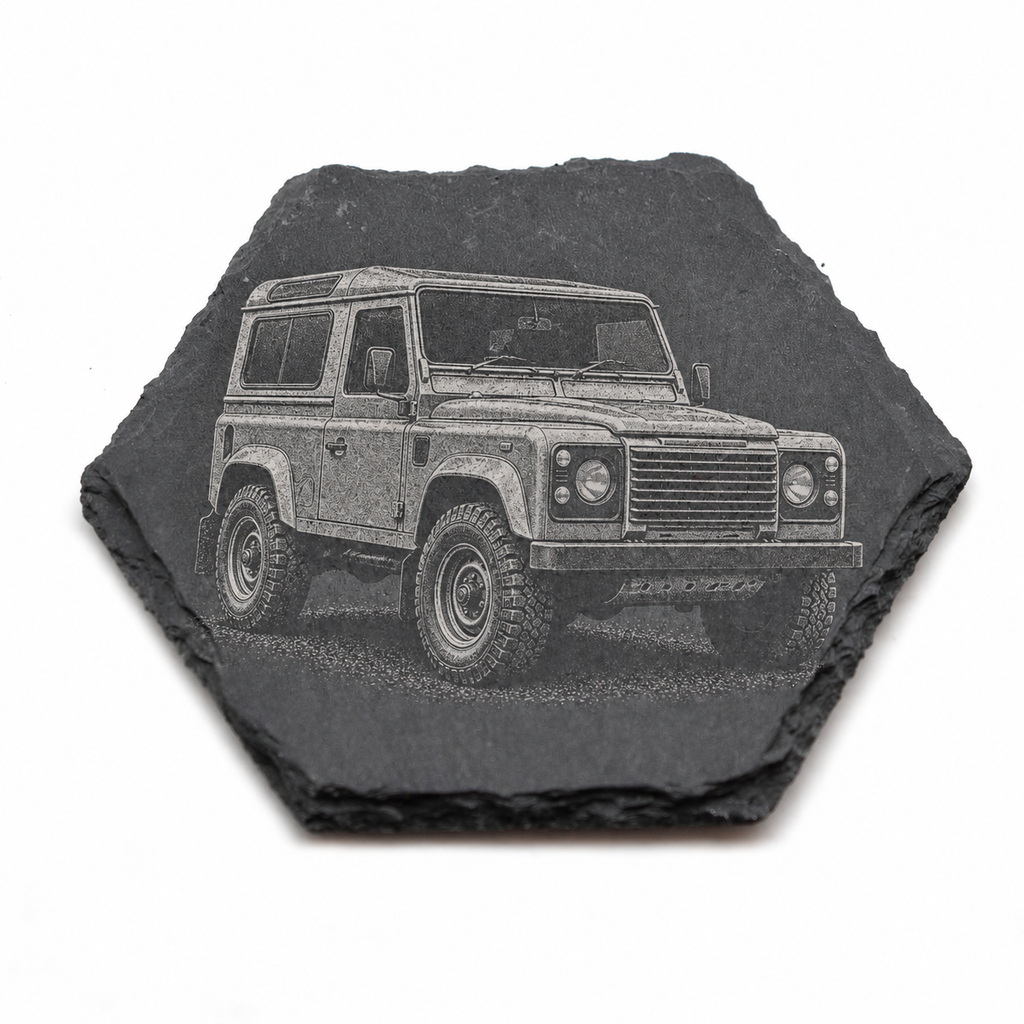 A hexagonal dark slate coaster featuring an engraved or printed illustration of a classic Land Rover Defender, shown on a plain white background.