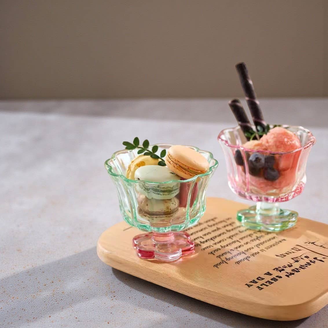 Croft & Cleo footed glass dessert cups with scalloped edges and colourful bases holding macarons and sorbet